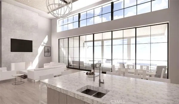 a living room with couches a flat screen tv and next to a window