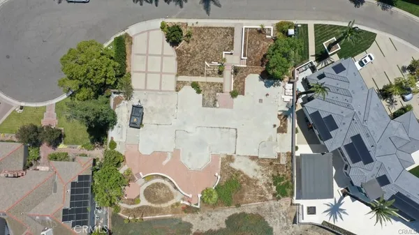 an aerial view of a house with a yard and large trees