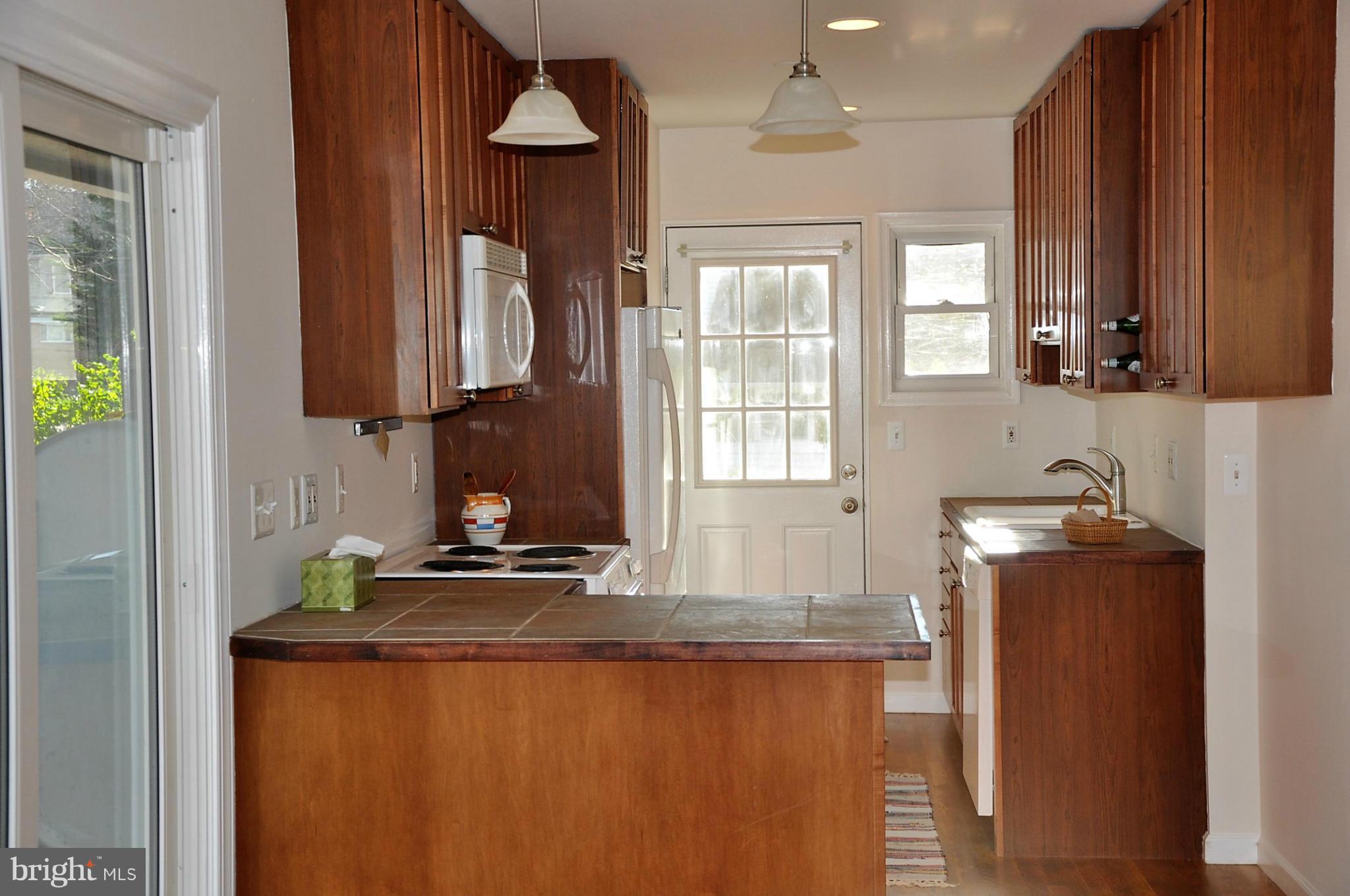 10303 Procter Street Silver Spring, MD 20901 - Photo 2 of 24 a kitchen with sink a window and cabinets