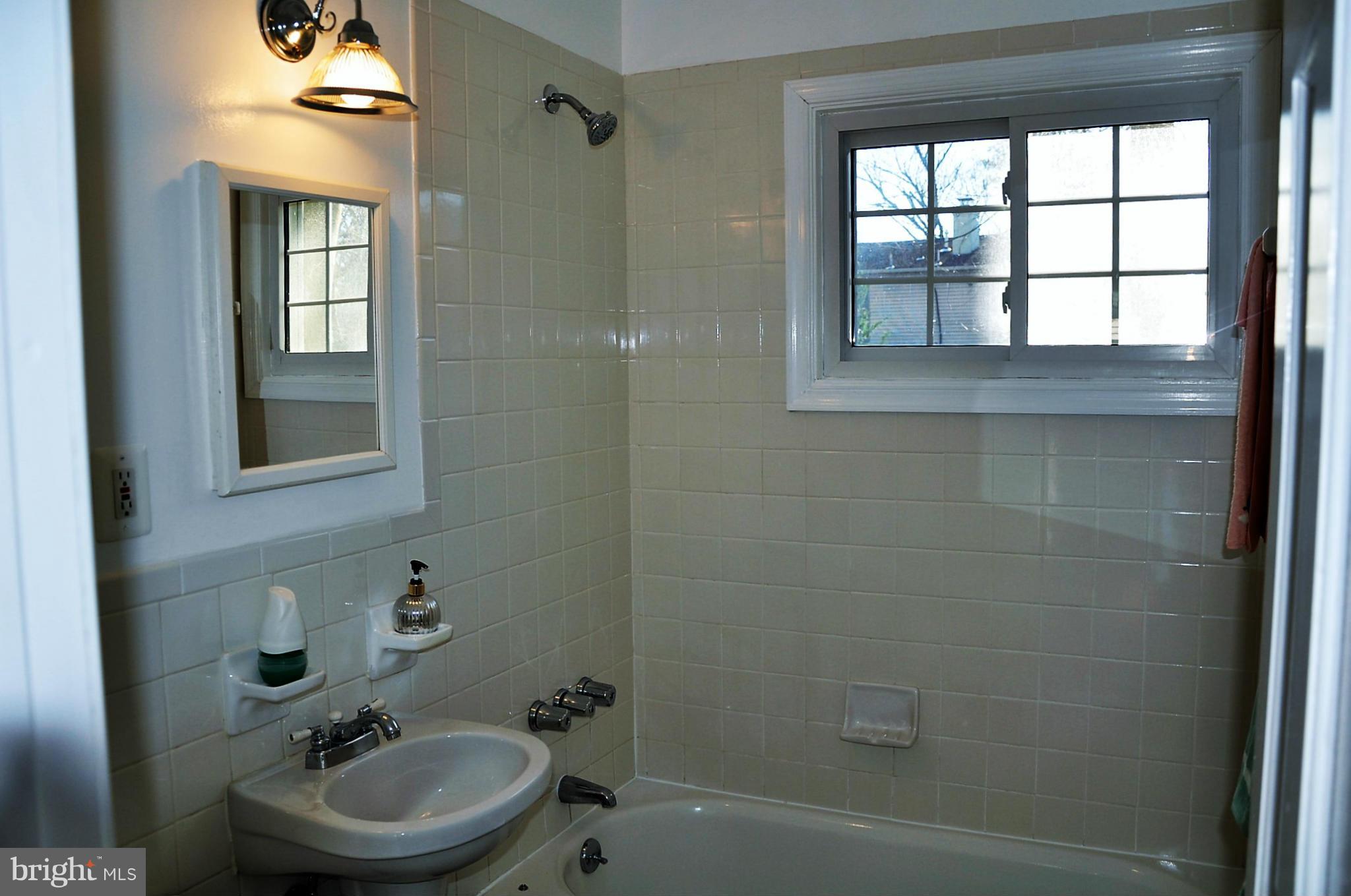 10303 Procter Street Silver Spring, MD 20901 - Photo 15 of 24 a bathroom with a sink a toilet and shower