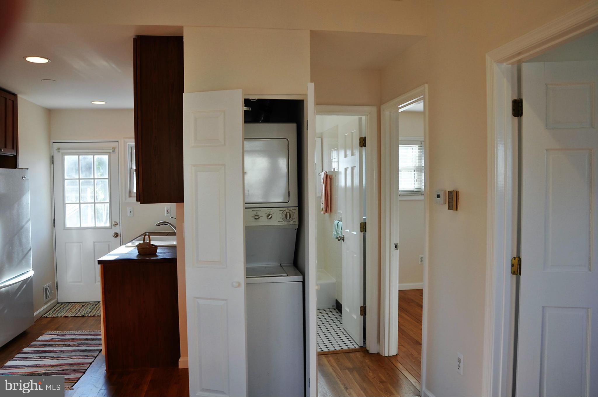10303 Procter Street Silver Spring, MD 20901 - Photo 16 of 24 a view of a hallway with bathroom and wooden floor