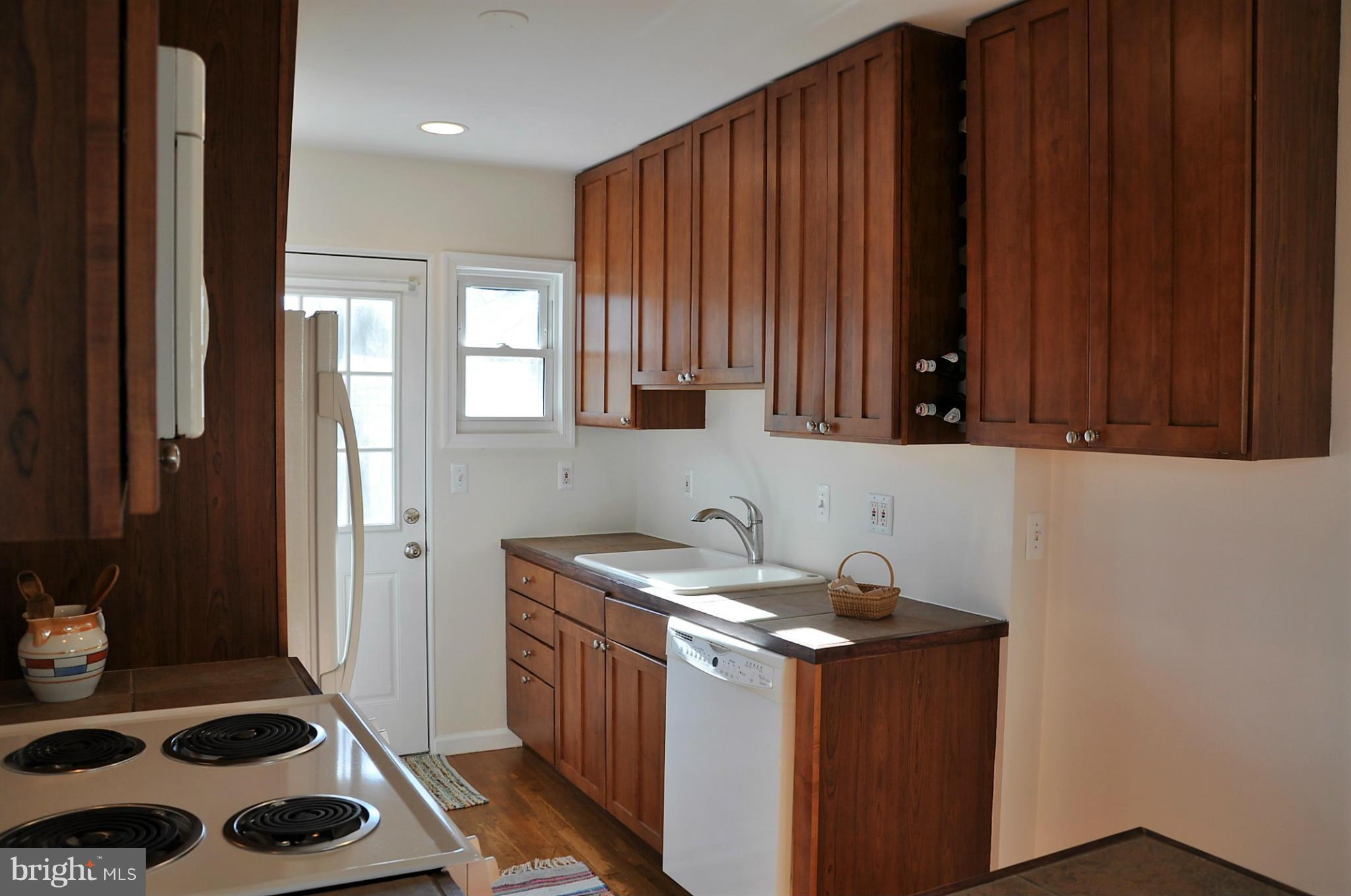 10303 Procter Street Silver Spring, MD 20901 - Photo 3 of 24 a kitchen with a sink a refrigerator and cabinets