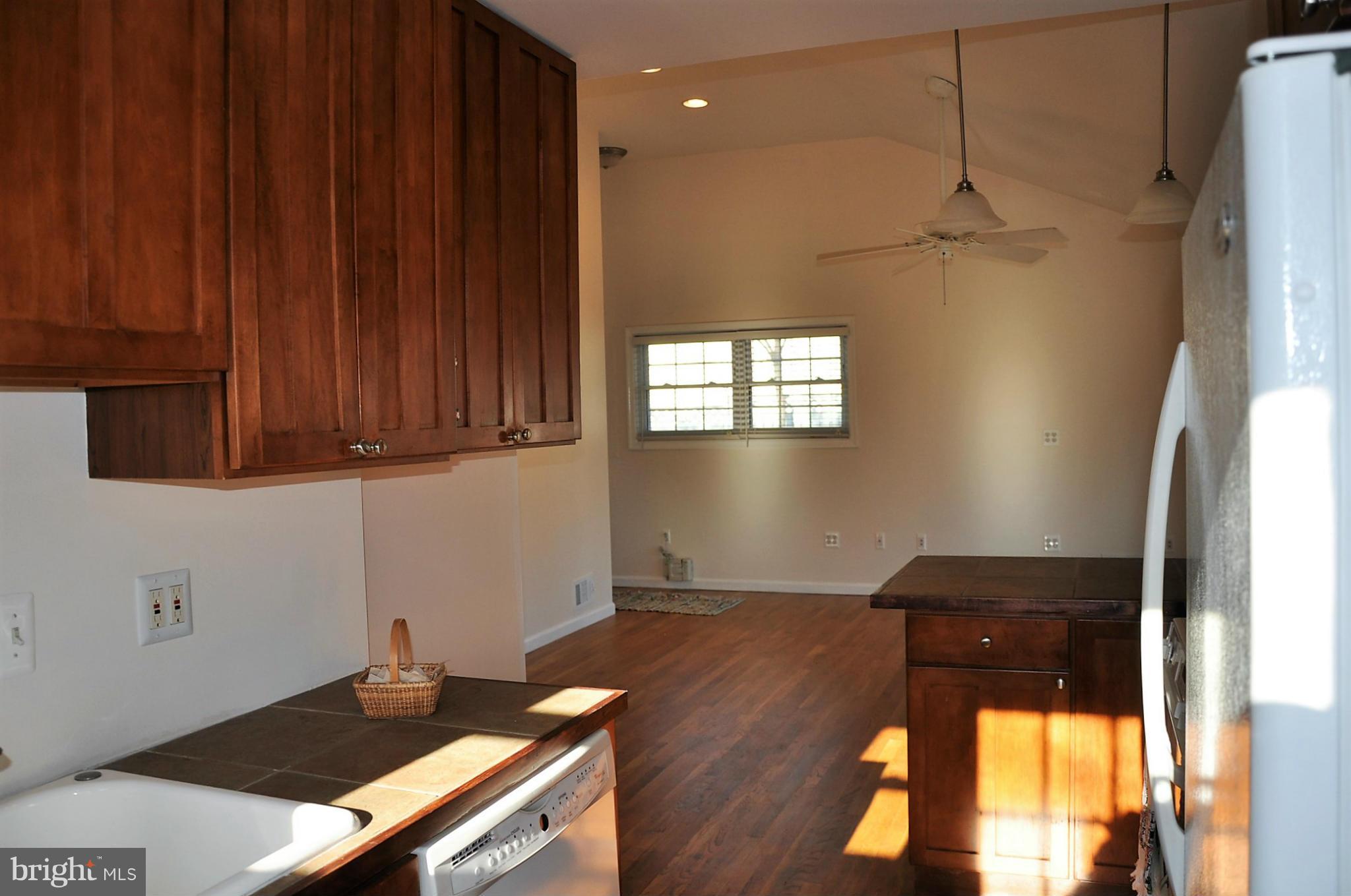 10303 Procter Street Silver Spring, MD 20901 - Photo 4 of 24 a kitchen with a wooden floor and a stove