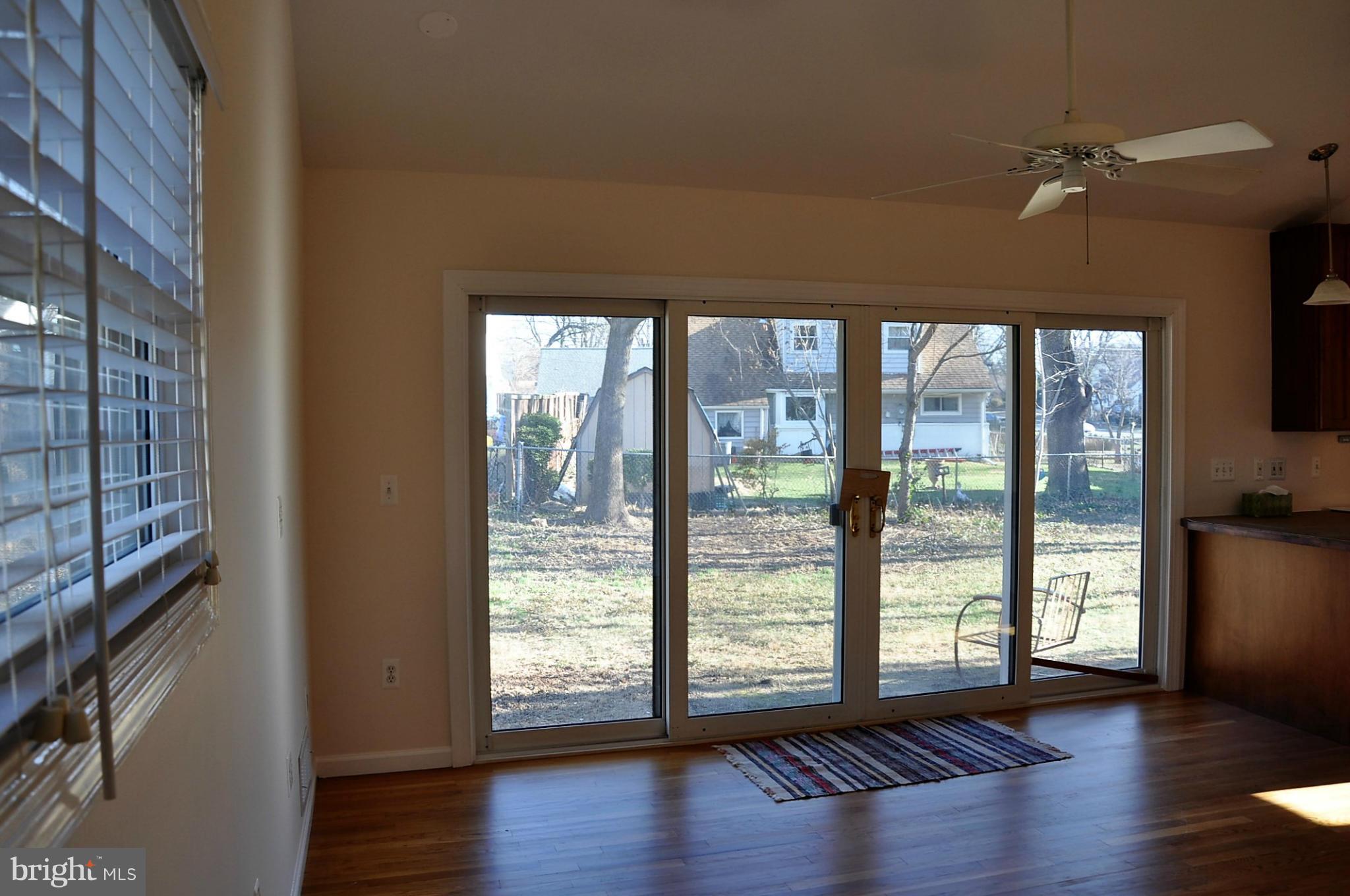 10303 Procter Street Silver Spring, MD 20901 - Photo 6 of 24 a view of an empty room with wooden floor and a window