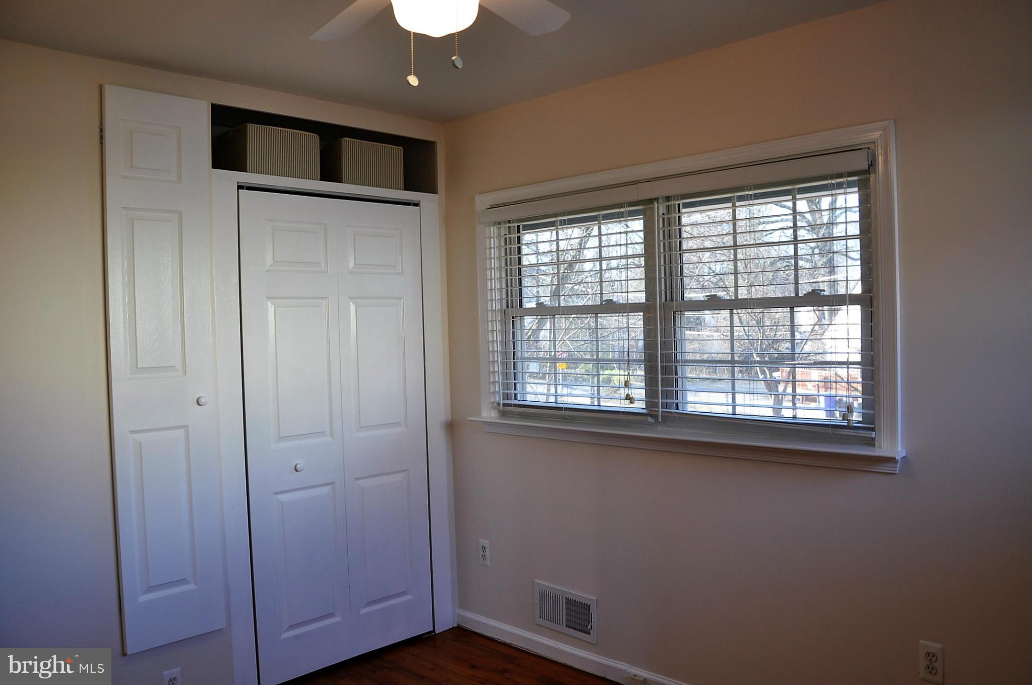 10303 Procter Street Silver Spring, MD 20901 - Photo 10 of 24 a view of empty room with wooden floor and fan
