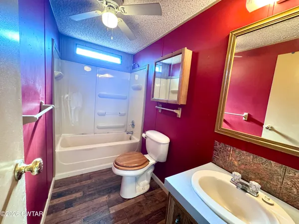 a bathroom with a sink toilet tub and shower