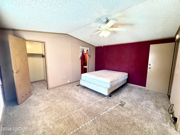 a bedroom with a bed and a mirror