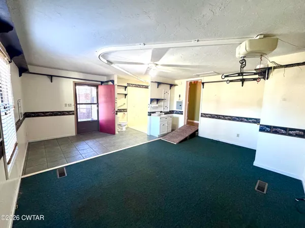 a kitchen with a refrigerator and a sink