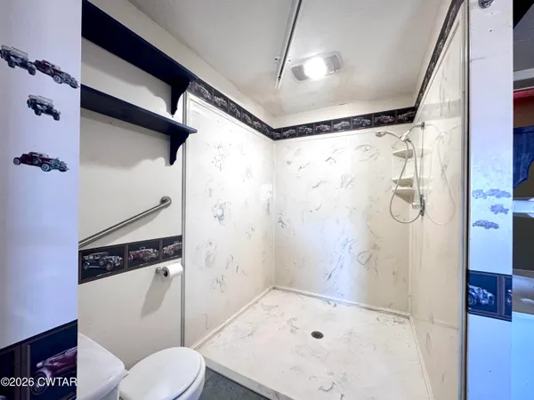 a bathroom with a shower toilet and sink