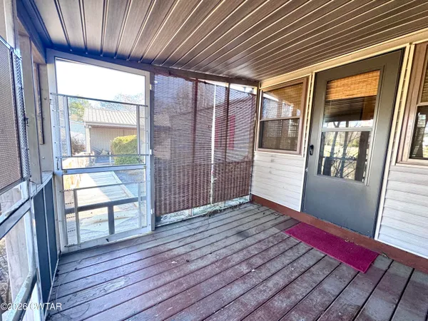 a view of a porch with wooden floor and a table