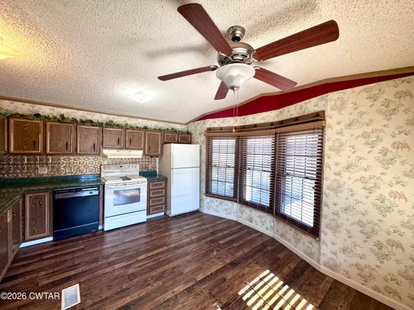 a view of a livingroom with a fireplace and wooden floor