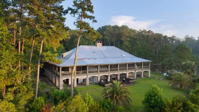 a view of house with a tree in the background