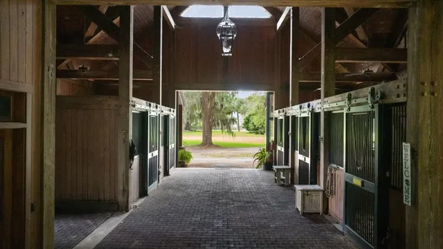 a living room with furniture a flat screen tv and a floor to ceiling window