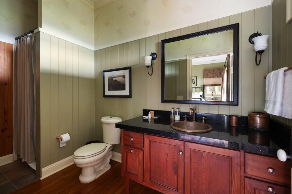 1300 Retreat Road Riceboro, GA 31323 - Photo 39 of 91 a bathroom with a granite countertop sink and a mirror