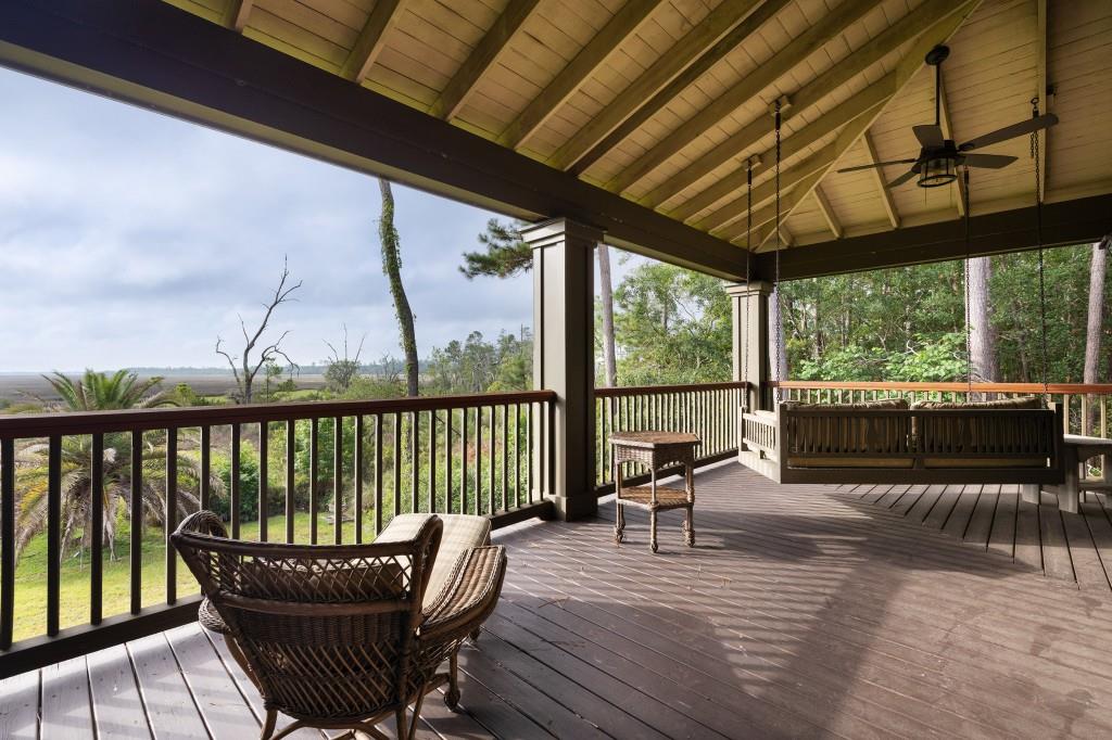 1300 Retreat Road Riceboro, GA 31323 - Photo 82 of 91 a view of a balcony with furniture and wooden floor