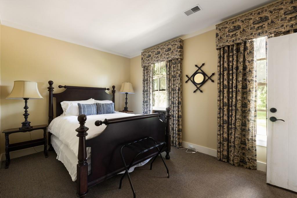 1300 Retreat Road Riceboro, GA 31323 - Photo 87 of 91 a bed sitting in a bedroom next to a window and a chair