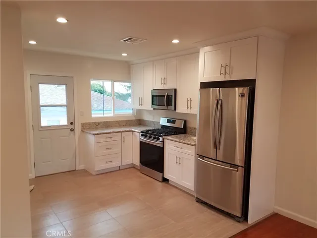 a kitchen with a refrigerator stove and microwave