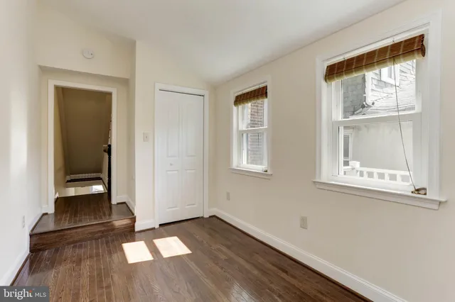 a view of a room with wooden floor and closet