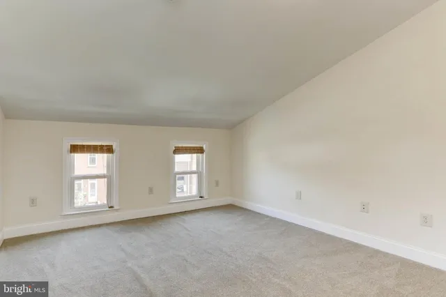 a view of an empty room and a window