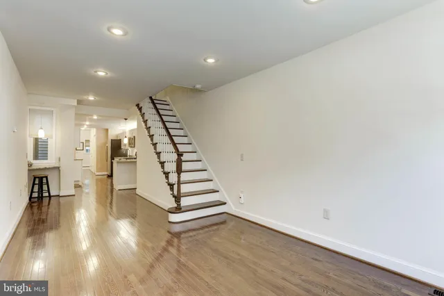 a view of entryway and hall with wooden floor