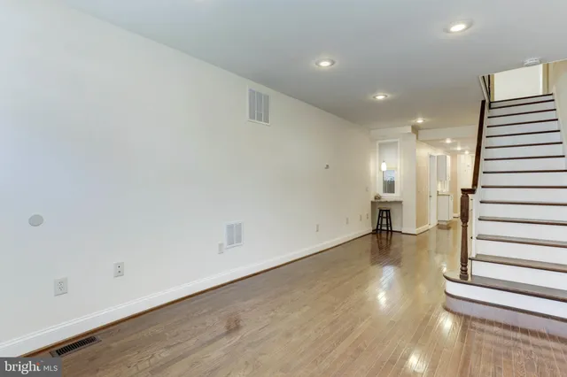 an empty room with wooden floor