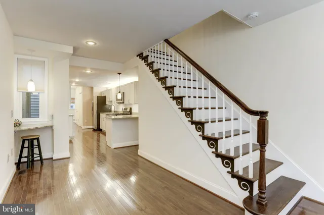 a view of entryway with wooden floor and stairs
