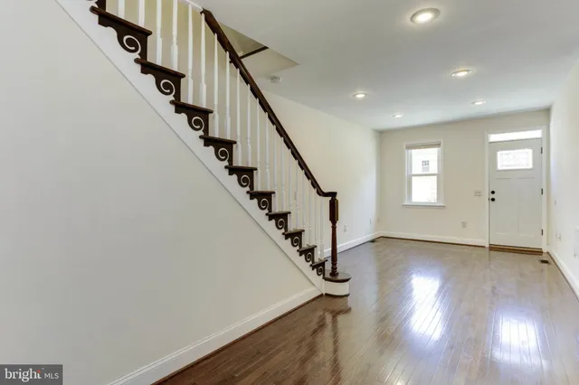 a view of an entryway with wooden floor and stairs