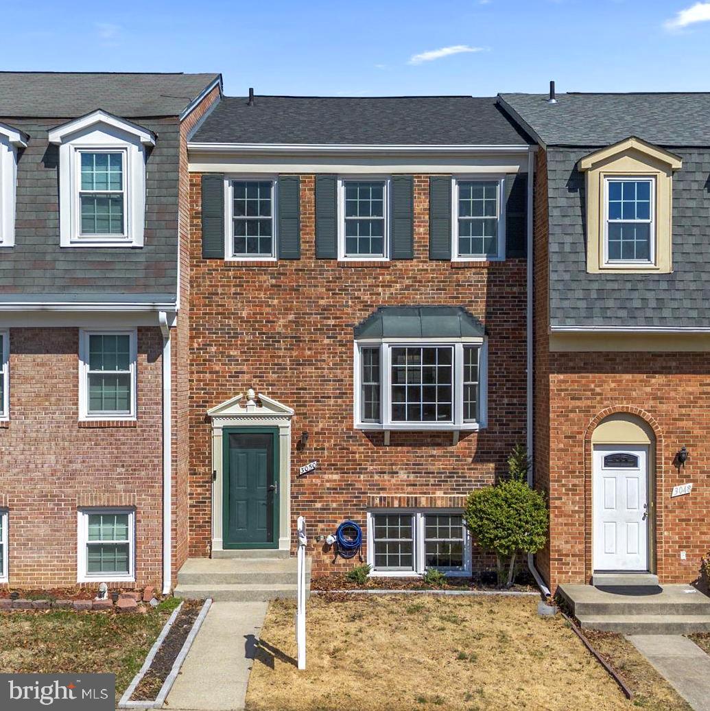 front view of a brick house with a windows