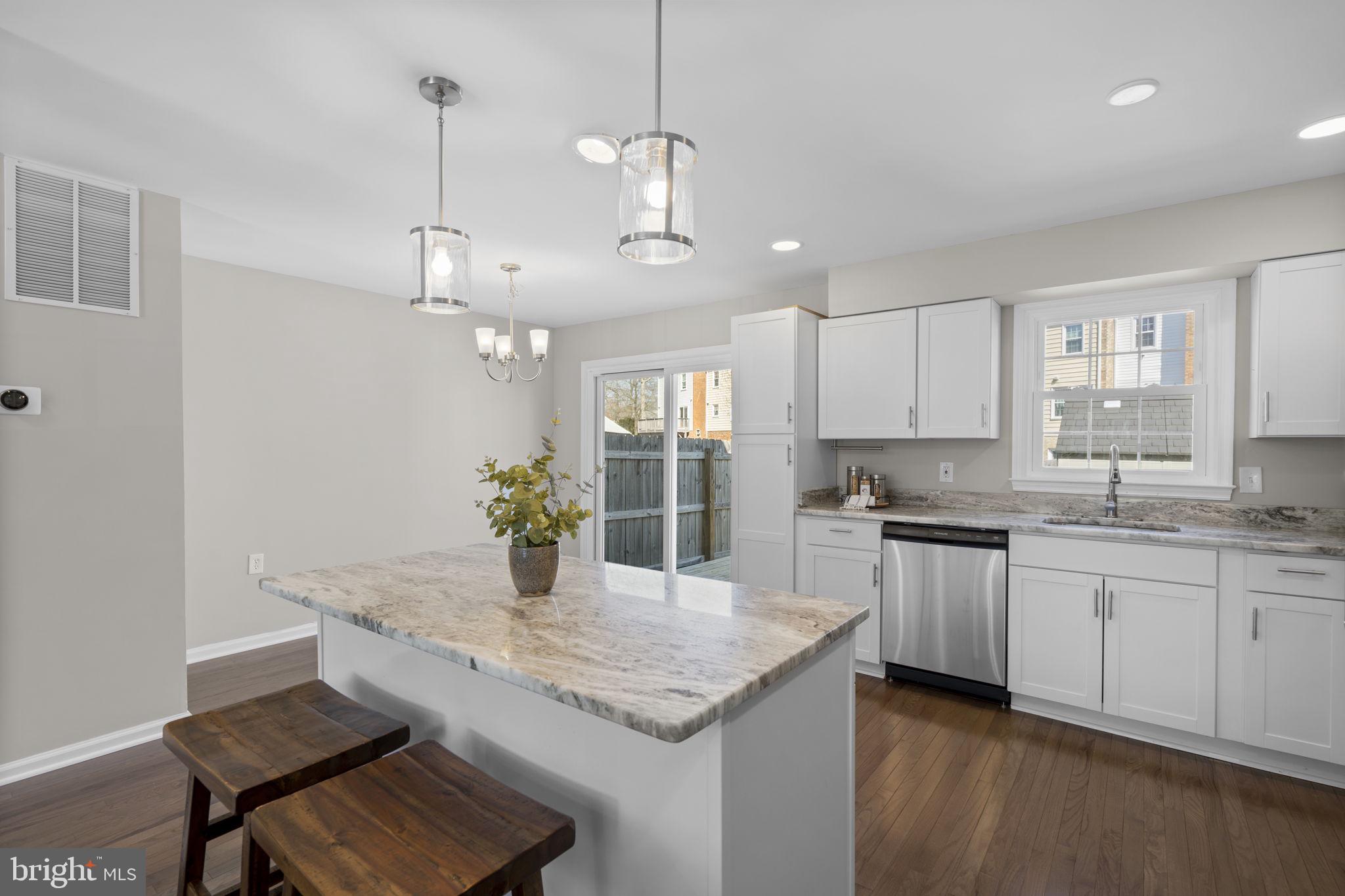 3050 Seminole Road Woodbridge, VA 22192 - Photo 7 of 35 a kitchen with center island white cabinets and refrigerator