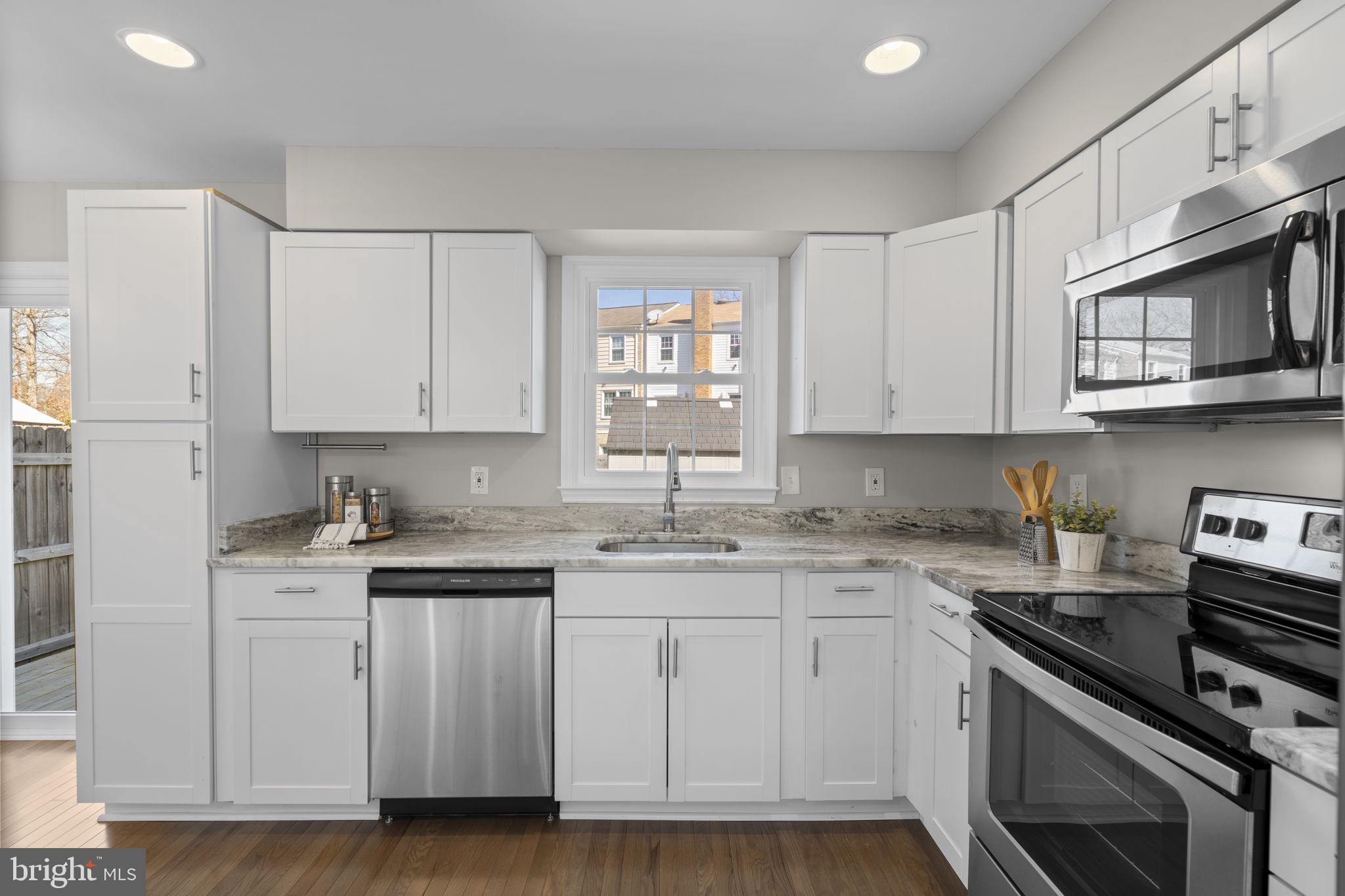 3050 Seminole Road Woodbridge, VA 22192 - Photo 8 of 35 a kitchen with stainless steel appliances granite countertop a sink stove and cabinets