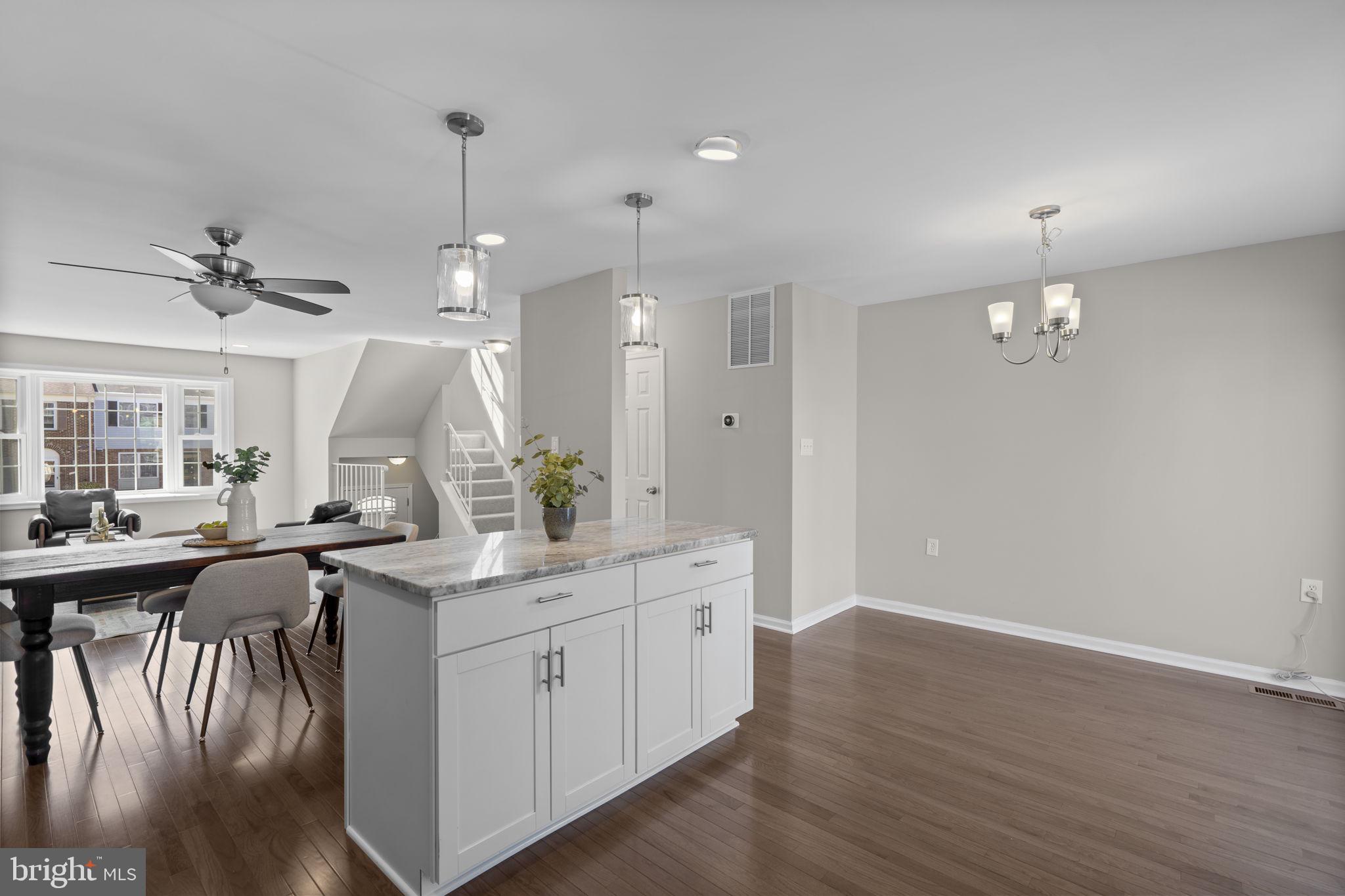 3050 Seminole Road Woodbridge, VA 22192 - Photo 9 of 35 a kitchen with a sink dishwasher and white cabinets with wooden floor