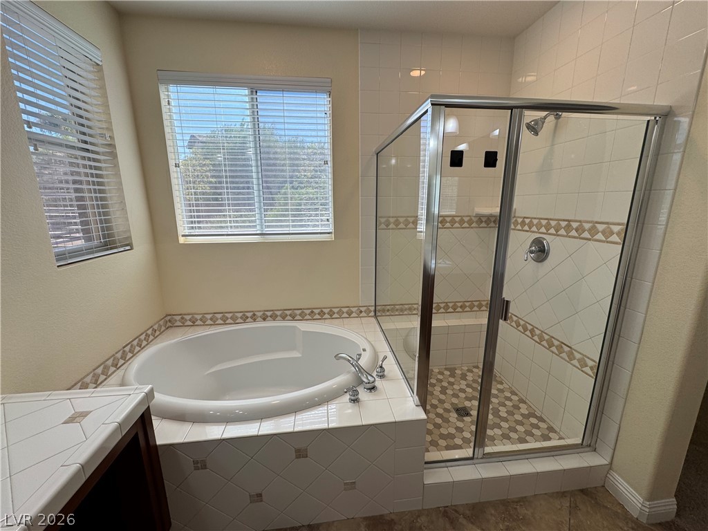 1333 Jamesbury Road Las Vegas, NV 89135 - Photo 33 of 43 Relaxation awaits in this primary bathroom featuring a spacious soaking tub and a separate walk-in shower.