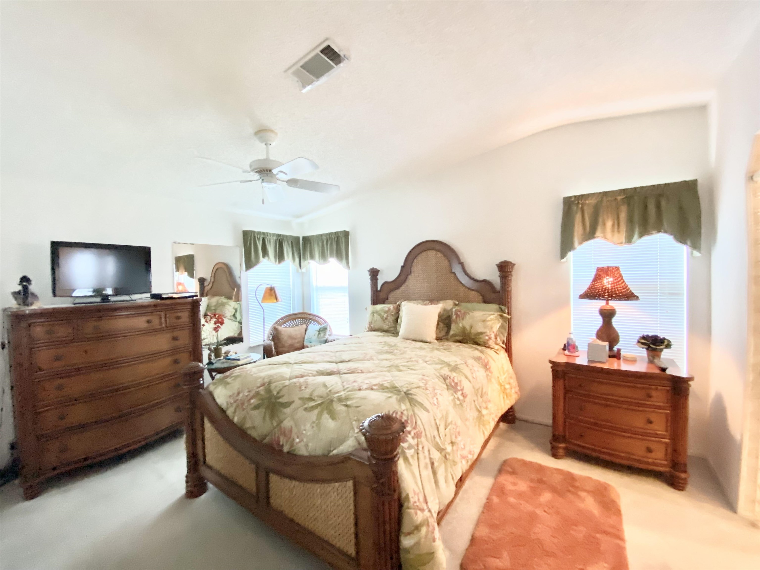 119 Anchorage Drive Beverly Beach, FL 32136 - Photo 13 of 33 a bedroom with a bed and a tv on the dresser