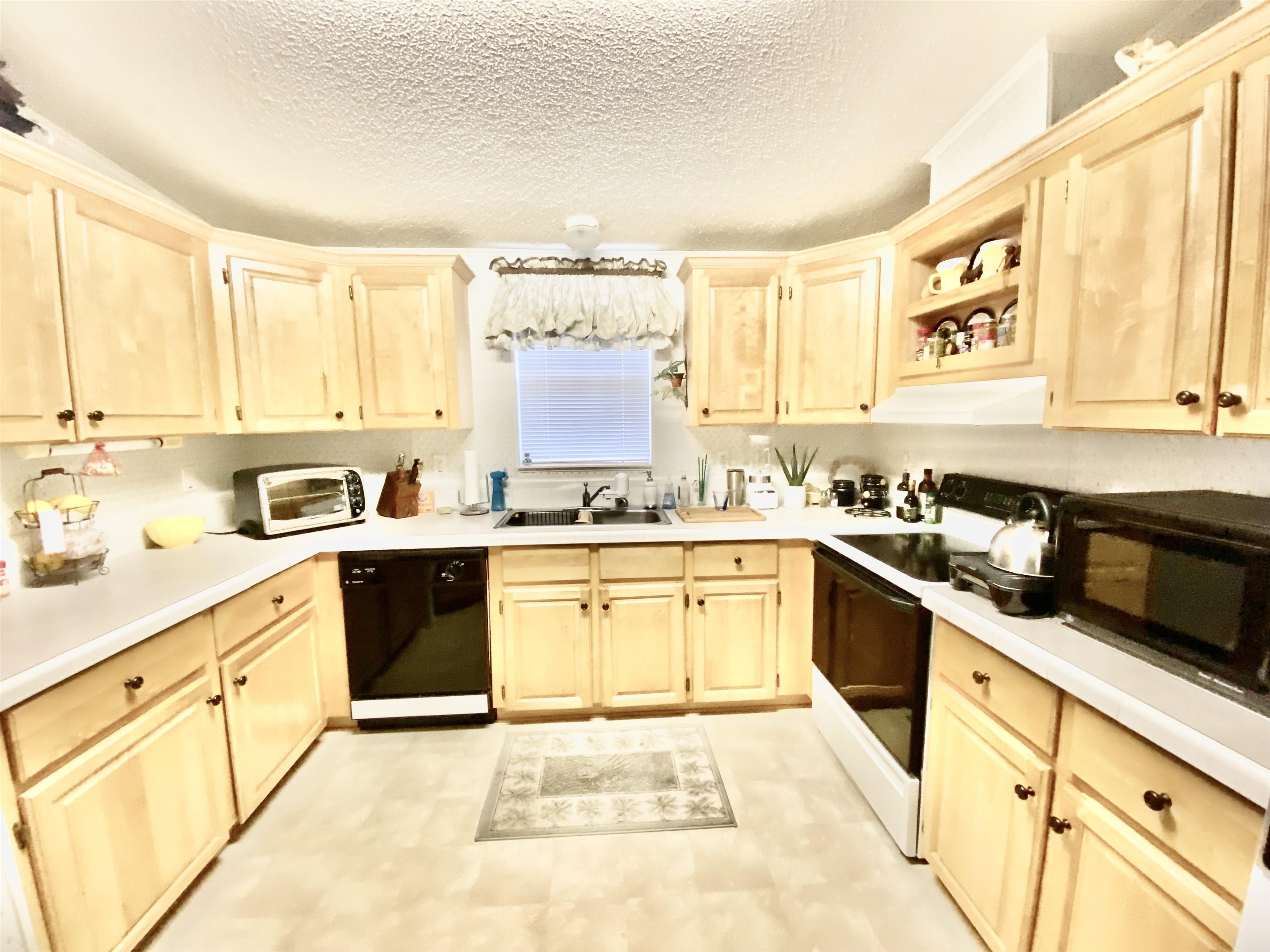 119 Anchorage Drive Beverly Beach, FL 32136 - Photo 8 of 33 a kitchen with stainless steel appliances granite countertop a stove a sink and a microwave