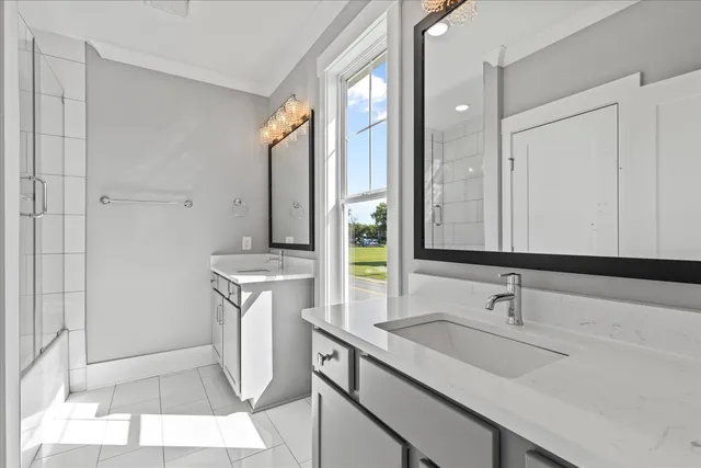 a bathroom with a sink double vanity and a mirror