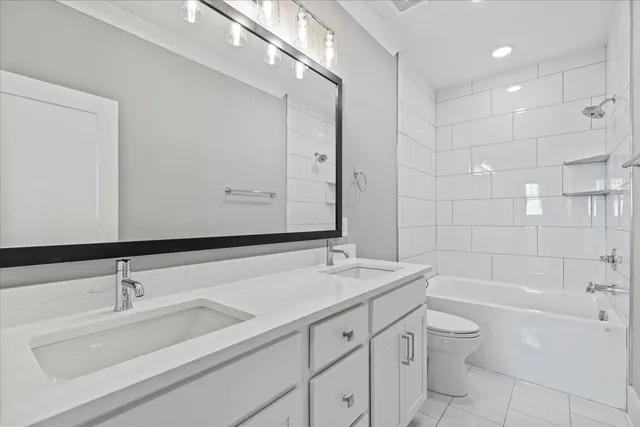 a bathroom with a sink double vanity granite toilet tub and shower
