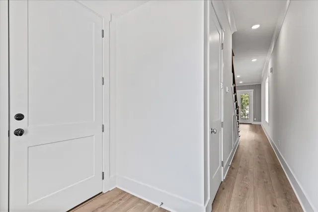 a view of a hallway with wooden floor