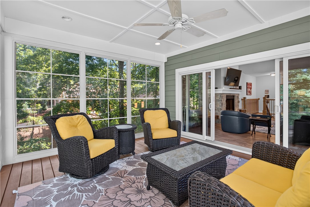 321 High Hampton Road Salem, SC 29676 - Photo 12 of 46 Floor-to-ceiling windows line a covered porch that opens directly into the main living space.