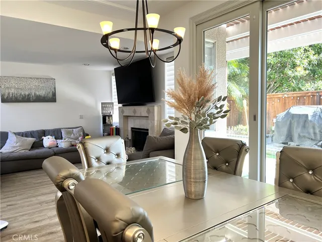 a living room with fireplace furniture and a chandelier