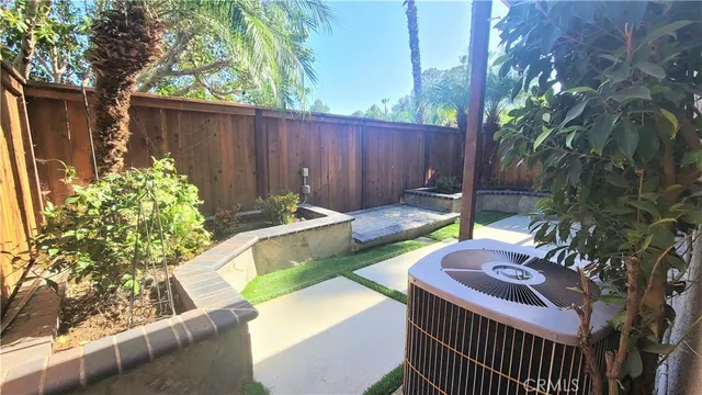 a view of a backyard with a tub and chairs