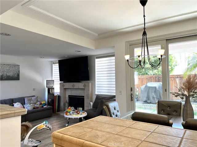 a bedroom with furniture a flat screen tv and a fireplace