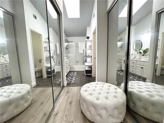 a living room with a large white cabinets and chandelier