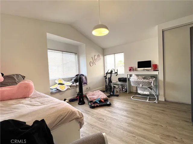 a bedroom with a bed a couch and a window