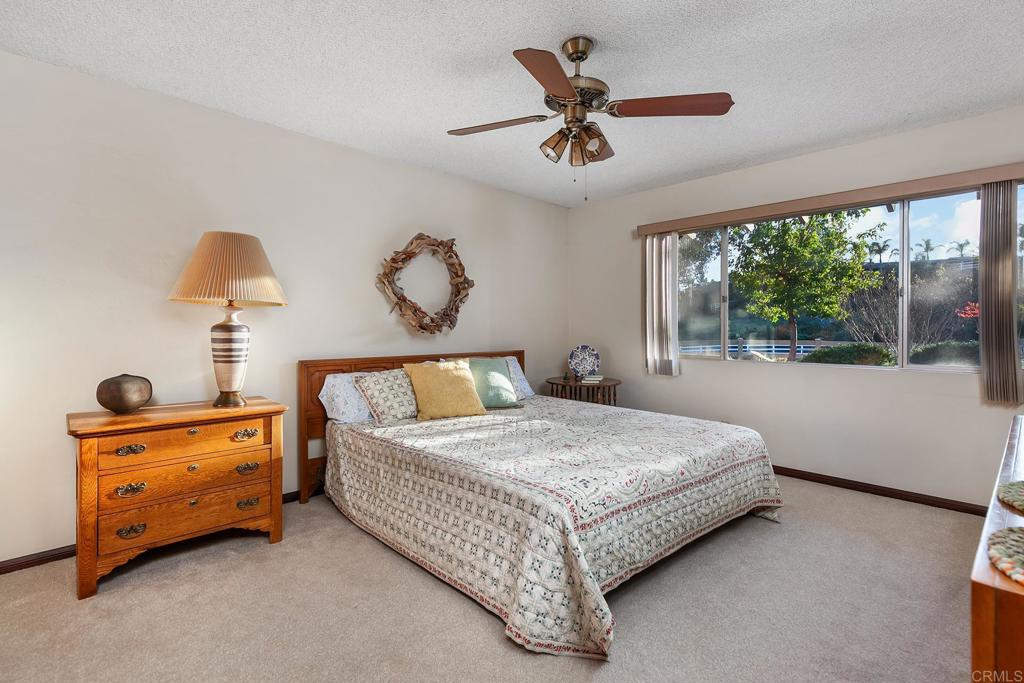 2686 Via Viejas Alpine, CA 91901 - Photo 20 of 64 a bedroom with a bed and a chandelier