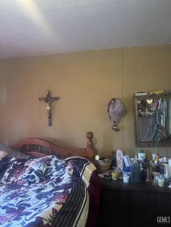 a bedroom with a bed and dresser