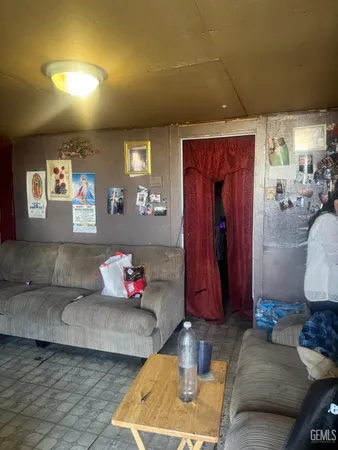 a living room with hard wood flooring and a couch