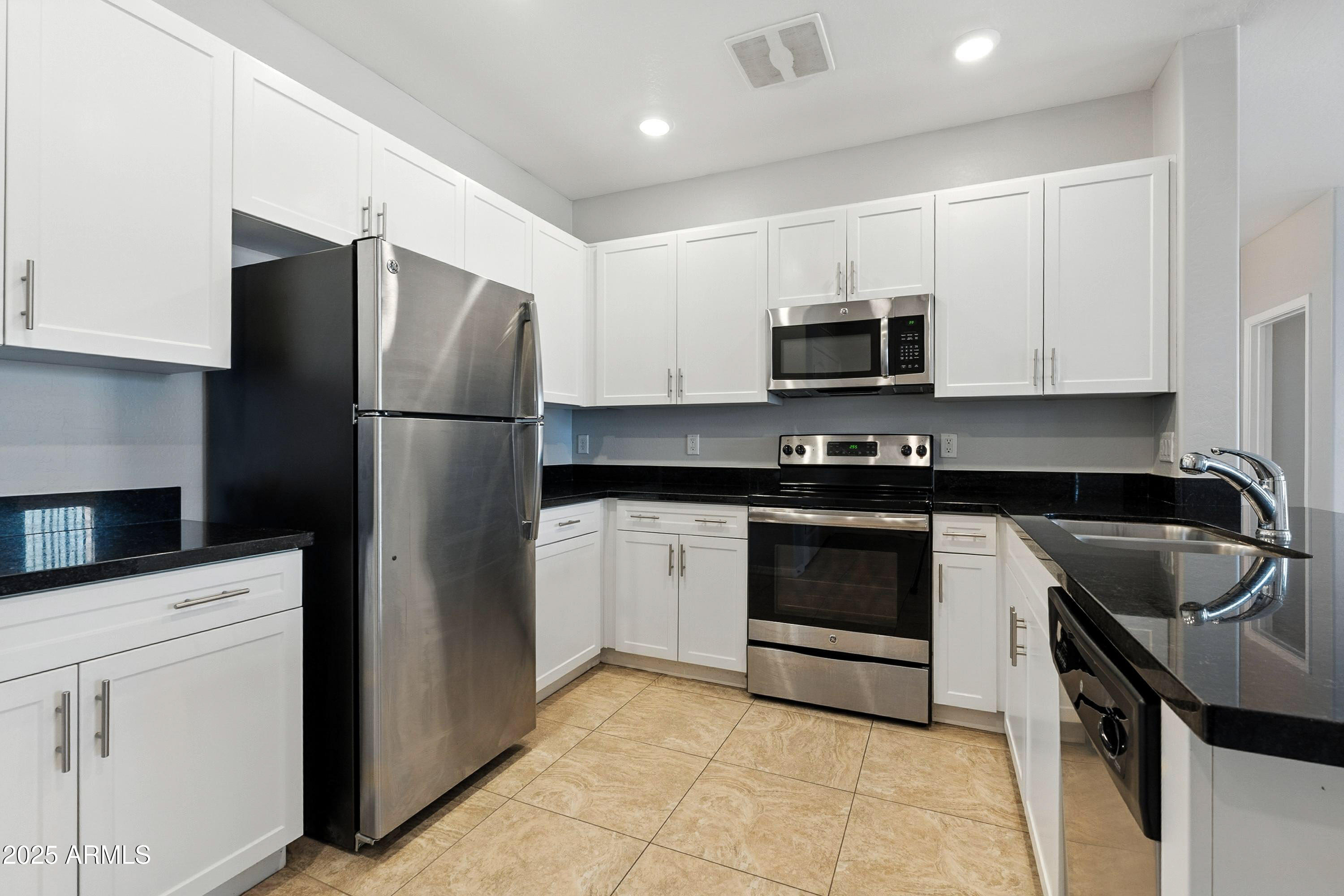 3330 South Gilbert Road, Unit 2062 Chandler, AZ 85286 - Photo 11 of 61 a kitchen with a refrigerator sink and microwave