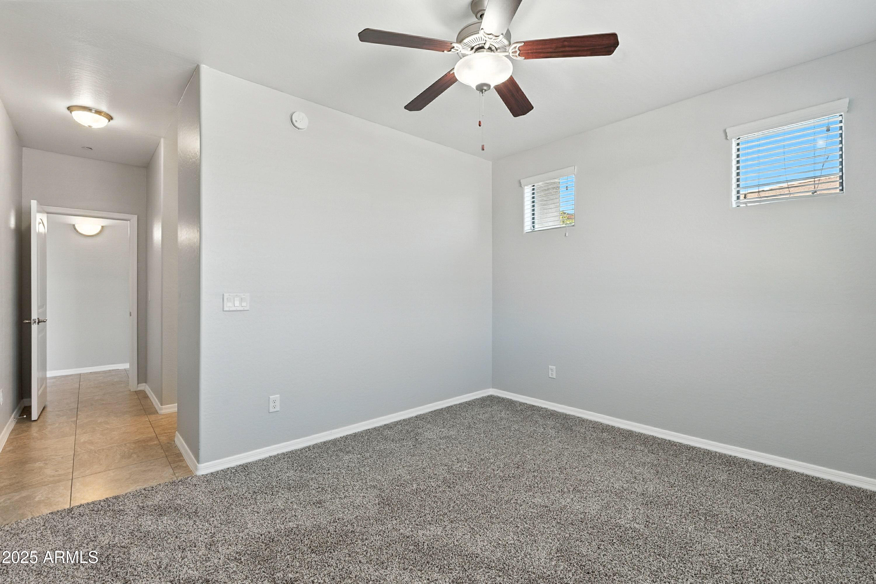 3330 South Gilbert Road, Unit 2062 Chandler, AZ 85286 - Photo 15 of 61 an empty room with closet and a chandelier fan