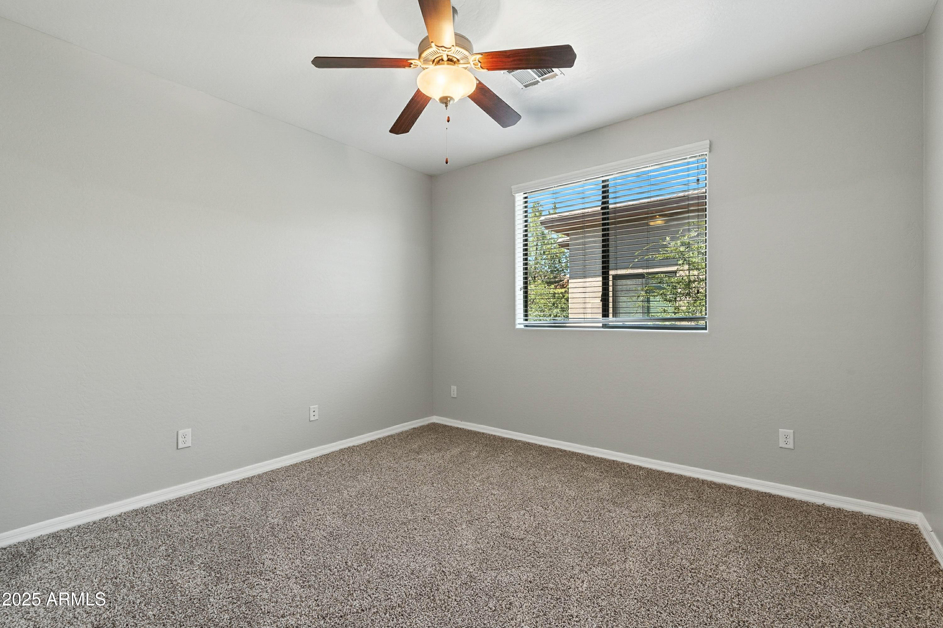3330 South Gilbert Road, Unit 2062 Chandler, AZ 85286 - Photo 18 of 61 an empty room with a window and a fan