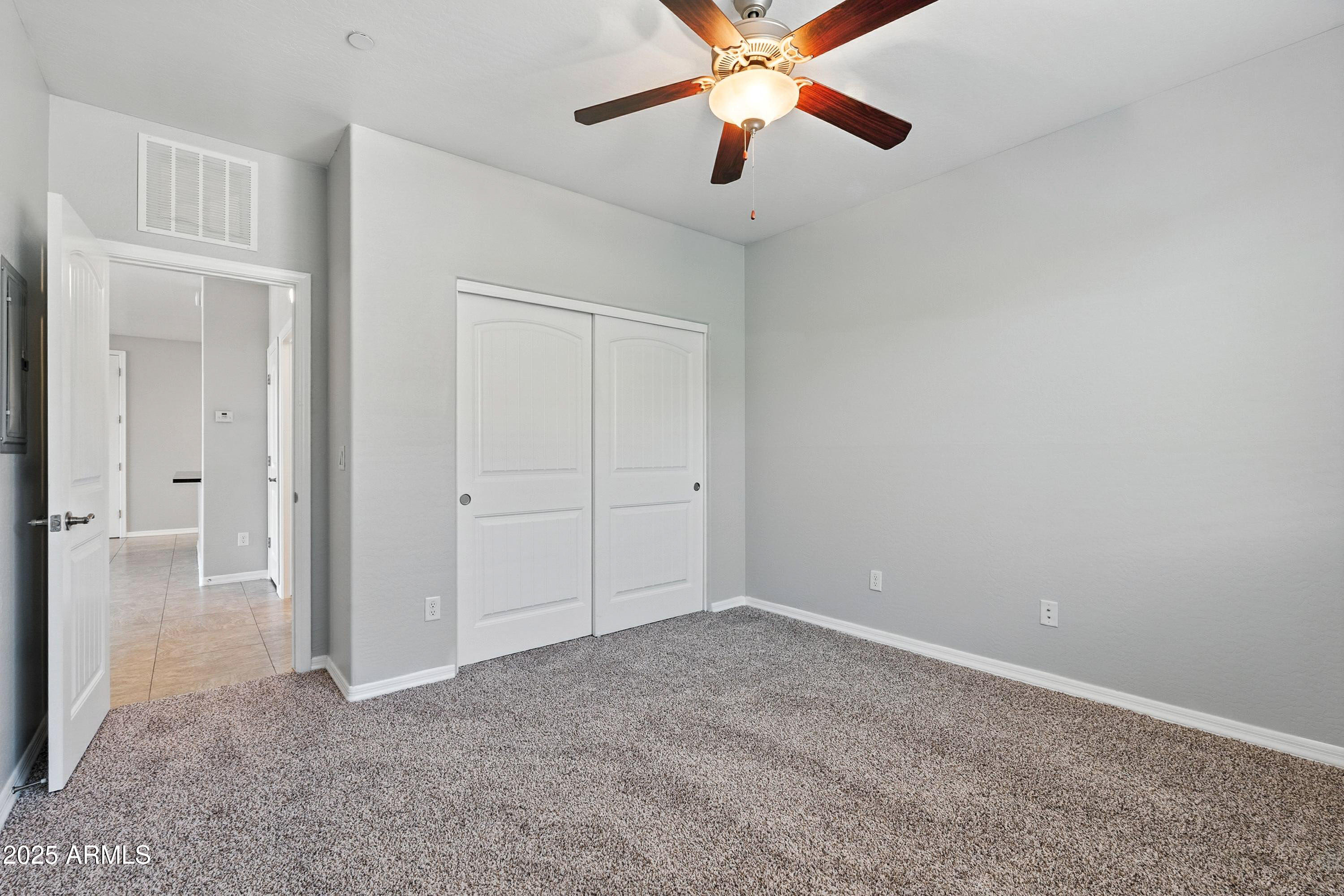 3330 South Gilbert Road, Unit 2062 Chandler, AZ 85286 - Photo 19 of 61 an empty room and chandelier fan